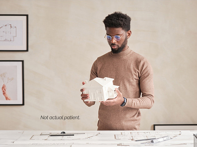 A man holding a house model