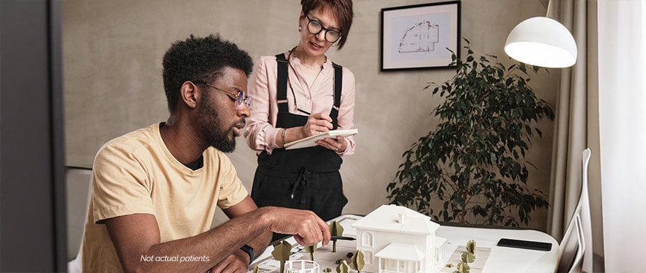 Man and woman working on blueprints together