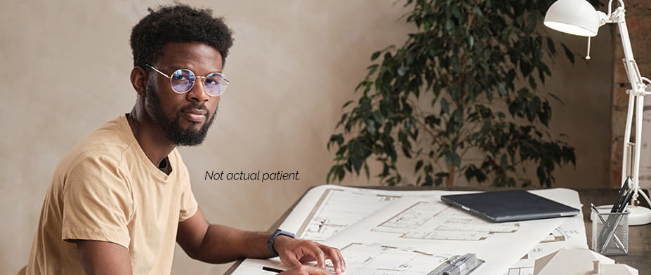 A man drawing construction plans