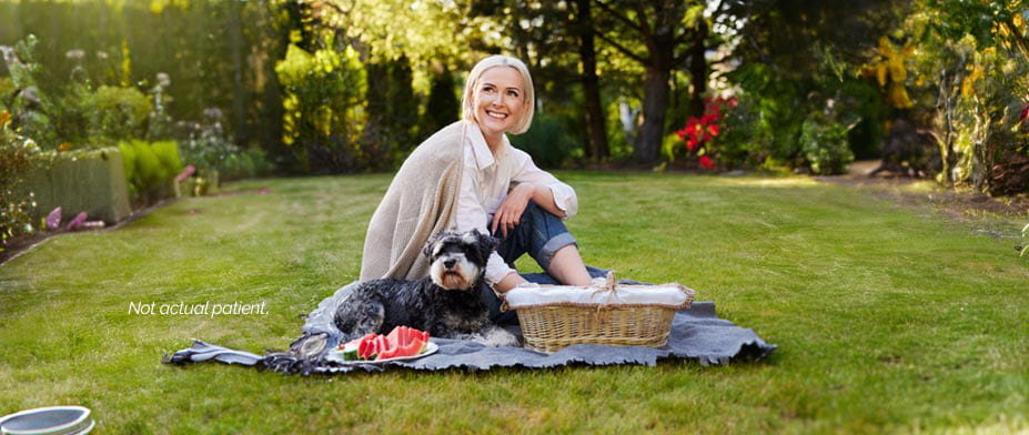 A woman smiling with her dog